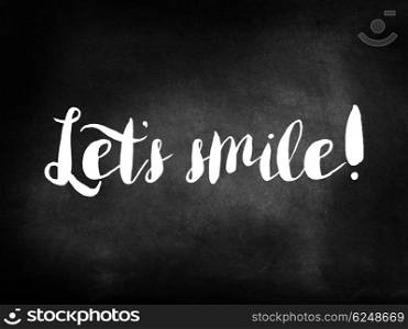Let&rsquo;s smile written on a chalkboard