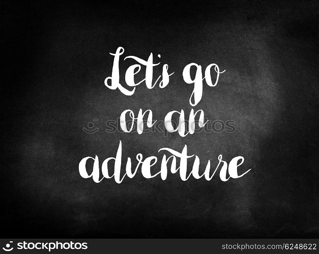 Let?s go on an adventure written on a chalkboard
