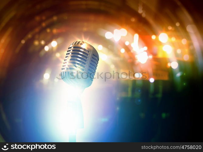 Let's sing! Stylish retro microphone on a colored background