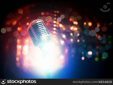 Let's sing! Stylish retro microphone on a colored background