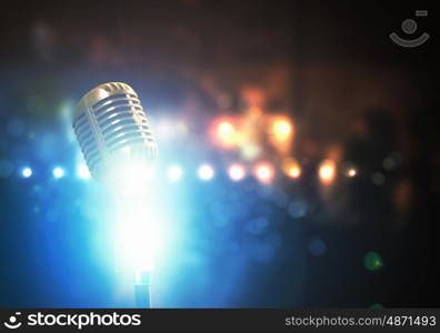 Let's sing! Stylish retro microphone on a colored background