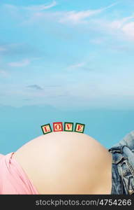 Letter boxes on the pregnant woman belly