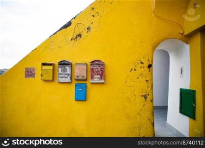 letter boxes on yellow wall