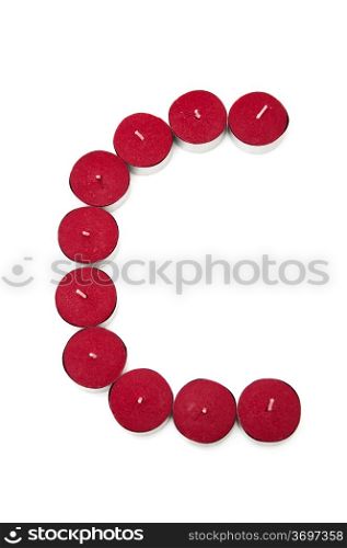 Letter C formed by candles on a white background
