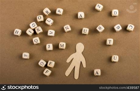 Letter cubes of made of wood and man figurine