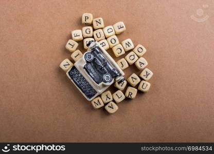 Letter cubes of made of wood around model typewritter