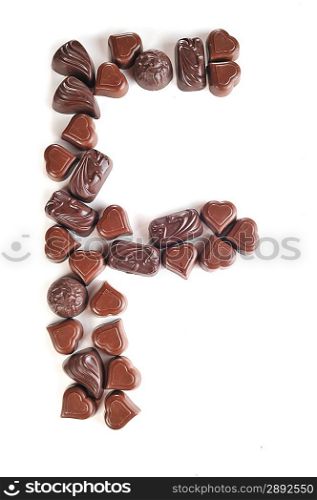 letter from chocolates on white background