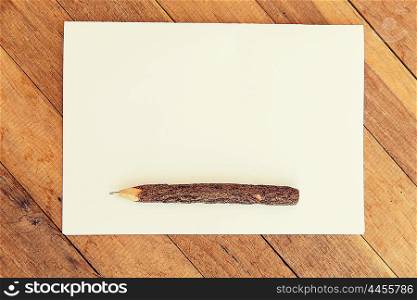 letter, message, mail and inspiration concept - white blank paper sheet with wooden pen on table