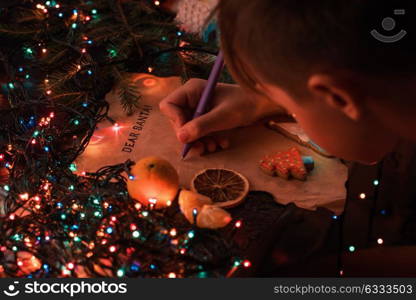 Letter to Santa. Boy writes a letter to Santa, cristmas background