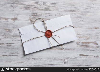 Letter with seal on table. Old post concept with envelope with wax seal on wooden surface