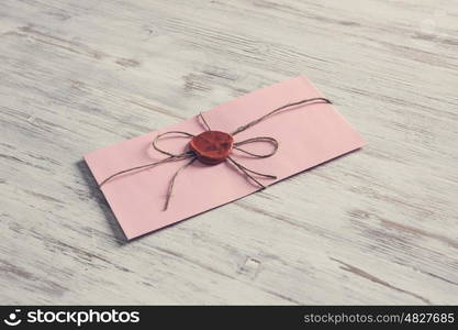 Letter with seal on table. Old post concept with envelope with wax seal on wooden surface