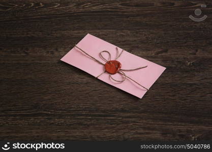 Letter with seal on table. Old post concept with envelope with wax seal on wooden surface