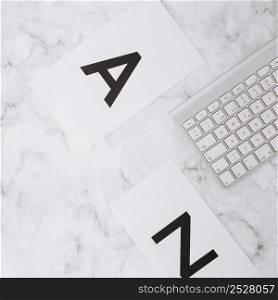 letter z white paper keyboard white marble textured background