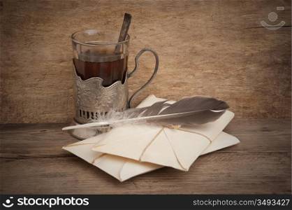 letters and a glass of tea , still life
