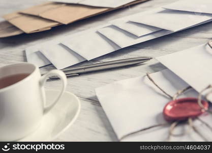 Letters with seal on table. Old post concept with envelope with wax seal on wooden surface