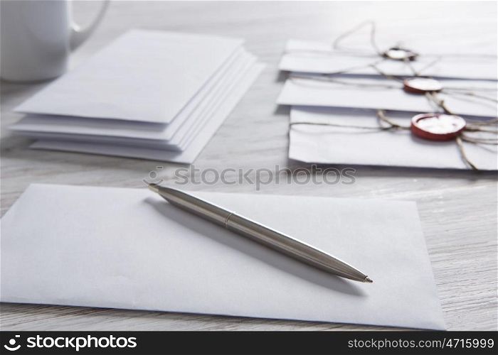 Letters with seal on table. Old post concept with envelope with wax seal and blank paper sheets on wooden surface