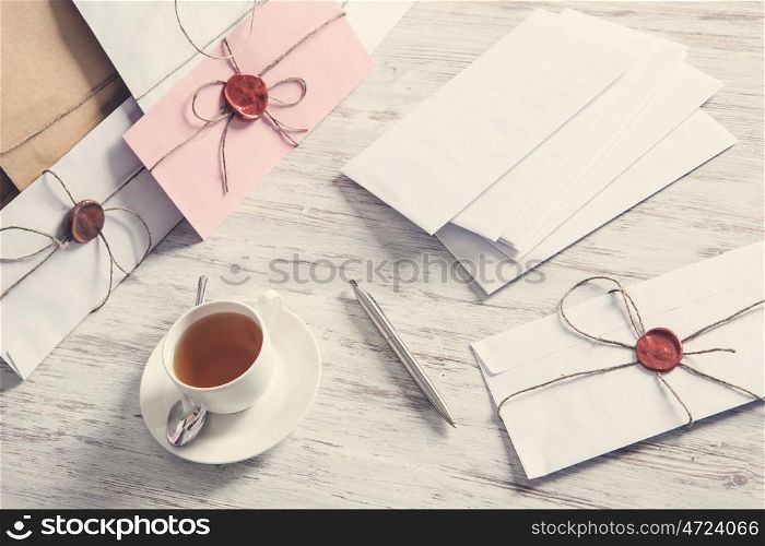 Letters with seal on table. Old post concept with envelope with wax seal on wooden surface