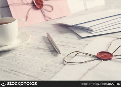 Letters with seal on table. Old post concept with envelope with wax seal on wooden surface