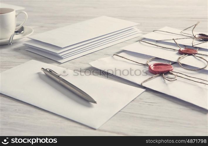 Letters with seal on table. Old post concept with envelope with wax seal on wooden surface