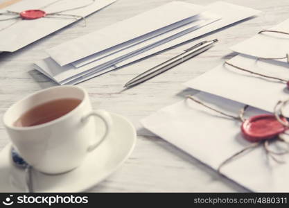 Letters with seal on table. Old post concept with envelope with wax seal on wooden surface