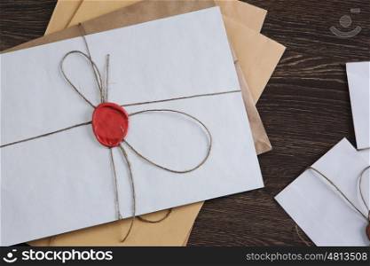 Letters with seal on table. Old post concept with envelopes with wax seal on wooden surface