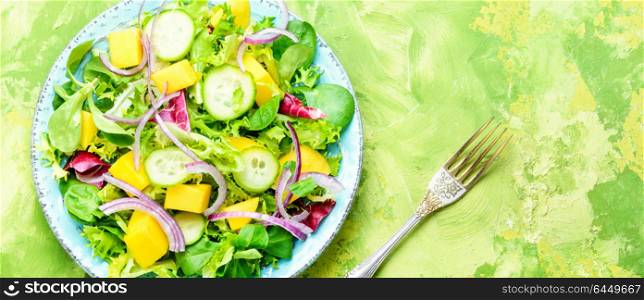 Lettuce salad with mango slices. Healthy vegan salad of vegetables, herbs and mango.Vegan salad.Diet menu