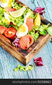 Lettuce salad with salmon. Diet salad with salmon,mango and fresh lettuce.Fish salad
