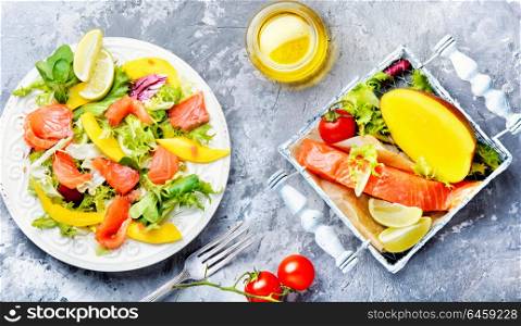 Lettuce salad with salmon. Diet salad with salmon,mango and fresh lettuce.Fish salad