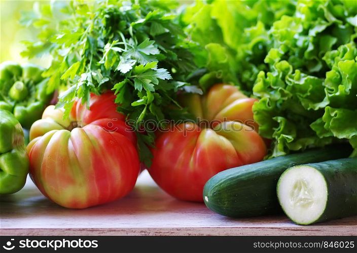 lettuce, tomatoes and cucumber on the table