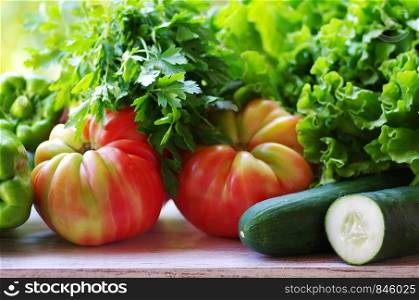 lettuce, tomatoes and cucumber on the table