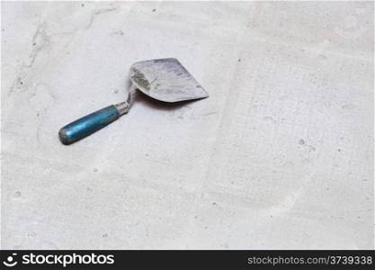 level Construction worker is tiling at home, tile floor adhesive