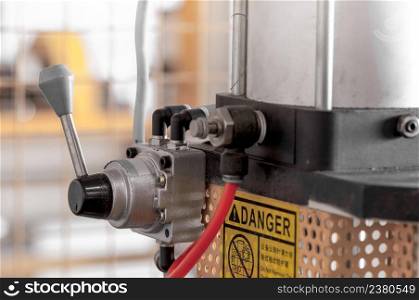 lever to control the machining equipment close up. the lever and mechanism to control the machinery in manufacturing