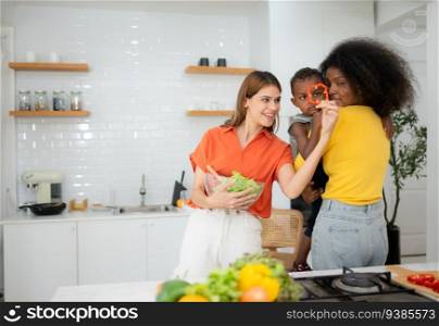 LGBT Couple and son cooking together in the kitchen at home