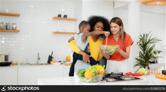 LGBT Couple and son cooking together in the kitchen at home