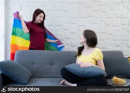 LGBT couples use rainbow flags to cover their loved ones. Working on the sofa in the living room of the house