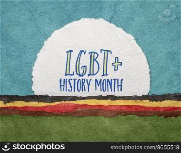 LGBT History Month - handwriting on a handmade watercolor paper against abstract paper landscape, reminder of cultural and heritage event