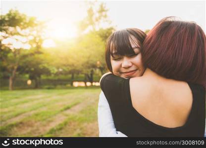 LGBT lesbian women couple moments happiness. Lesbian women couple together outdoors concept. Lesbian couple embraced together relation fall in love. Two asian women having fun together at park.