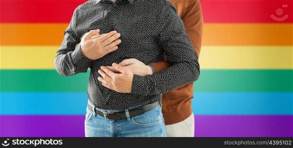 lgbt, same-sex relationships and homosexual concept - close up of hugging male gay couple over rainbow background. close up of hugging male gay couple over rainbow. close up of hugging male gay couple over rainbow