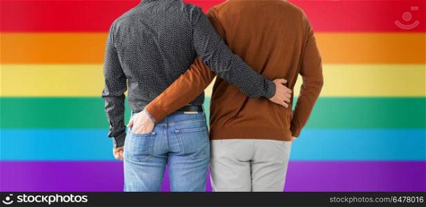 lgbt, same-sex relationships and homosexual concept - close up of hugging male gay couple over rainbow background. close up of hugging male gay couple over rainbow. close up of hugging male gay couple over rainbow