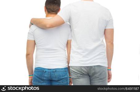 lgbt, same-sex relationships and homosexual concept - close up of hugging male couple wearing gay pride rainbow awareness wristbands. male couple with gay pride rainbow wristbands. male couple with gay pride rainbow wristbands