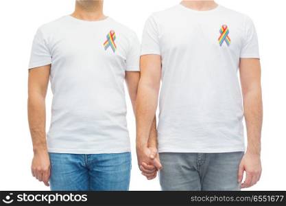 lgbt, same-sex relationships and homosexual concept - close up of male couple with gay pride rainbow awareness ribbons. close up of couple with gay pride rainbow ribbons. close up of couple with gay pride rainbow ribbons