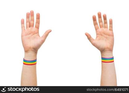 lgbt, same-sex relationships and homosexual concept - close up of male hands wearing gay pride awareness wristbands. hands with gay pride rainbow wristbands. hands with gay pride rainbow wristbands