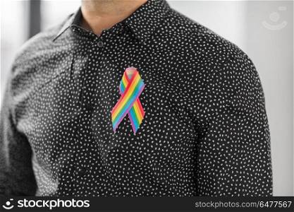 lgbt, same-sex relationships and homosexual concept - close up of man with gay pride rainbow awareness ribbon on his chest. man with gay pride rainbow awareness ribbon. man with gay pride rainbow awareness ribbon