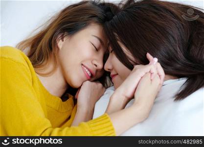 LGBT, Young cute asian lesbians lying and smiling on white bed together in the morning, couple lesbians happy moment n