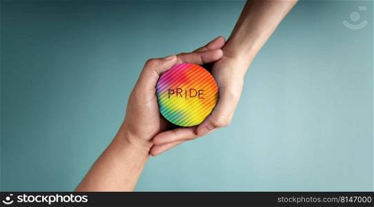 LGBTQ Concepts. Hands of Couple Embracing a Pride Rainbow Circle Together. Valentines Day. Pride month. Sign of Gender, Human Rights and Protest