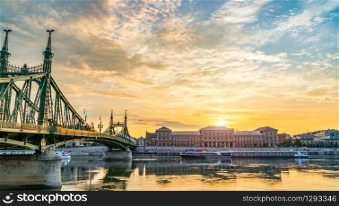 Liberty Bridge and touristic boats in Budapest at sunrise. Liberty Bridge and boats