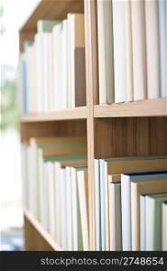 Library - row of new books on bookshelf