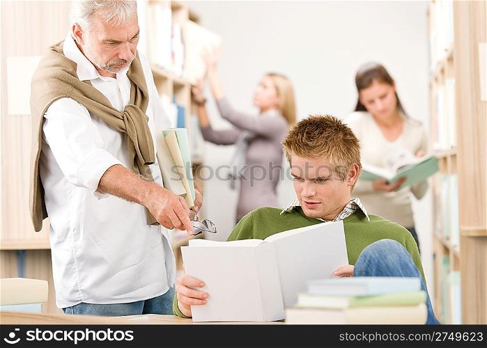 Library - student with mature professor at high school with book