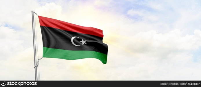 Libya flag waving on sky background. 3D Rendering