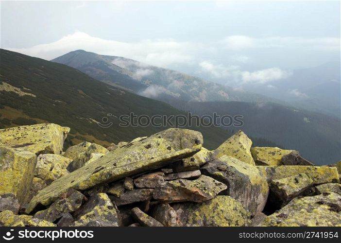 lichen-grown stones and clouds in Gorgany region of Carpathian mountains (Ukraine)